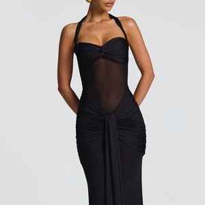 Detail of ruched black bodycon dress with sheer mesh panel and halter neckline