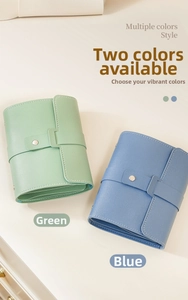 Detail view of green and blue leather jewelry pouches with button strap and fine stitching