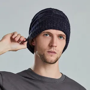 Thick navy mixed-knit beanie with metal accent and warm lining on model