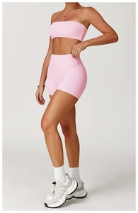 Detail of pink brushed high-waisted yoga shorts and sports top with seamless texture