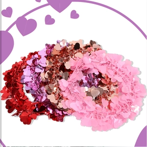 Macro detail of glossy red and rose gold heart wreaths for festive wall decoration