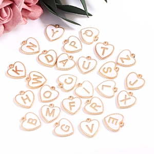 Golden heart-shaped enamel A-Z initial charms with white finish for DIY jewelry