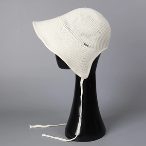 Close-up of white knitted sun hat with breathable mesh texture and adjustable long straps