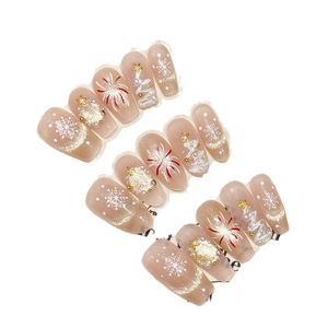 Christmas themed press-on nails with white snowflakes, golden trees and glitter details