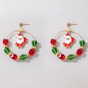 Close-up of Christmas hoop earrings with Santa Claus charm and festive red green beads