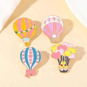 Set of four colorful hot air balloon enamel brooches with gold plating and vibrant pins