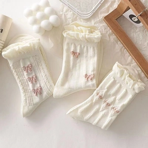 White lace trim socks with pink bows and ruffled cuffs in a three-pair variety pack