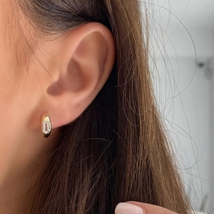 Close-up of S925 sterling silver square diamond hoop earring worn on the earlobe
