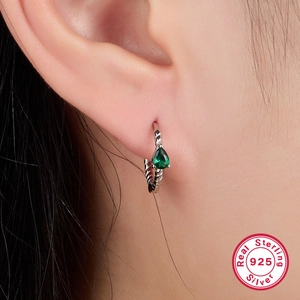 Detail of S925 sterling silver hoop earring with pear-cut green turquoise zircon on model