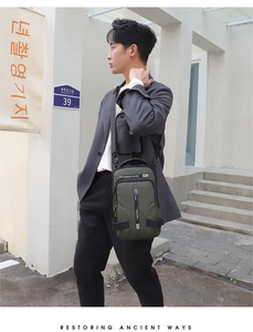 Detail view of military green waterproof chest bag with vertical zipper and buckle strap