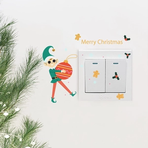 Christmas elf wall sticker set with Merry Christmas lettering on white light switch panel