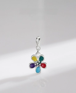 Macro view of multi-color enamel silver flower pendant with vibrant petals and polished beads