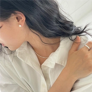 Elegant 925 sterling silver brushed bead earrings worn by a model in natural light