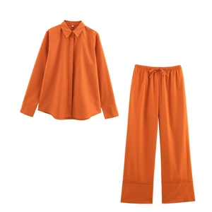 Bright orange two-piece linen shirt and wide-leg pants set with a drawstring waist