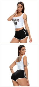 Close-up of white cropped tank top and black sports shorts with side stripes