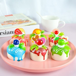 Set of six colorful realistic faux fruit cakes on a pink plate for home decor