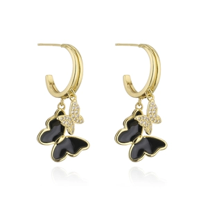 Detail of gold-plated butterfly hoop earrings with black enamel and white zircons