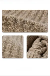 Macro view of warm oat-colored chunky knit fabric showing soft wool blend texture
