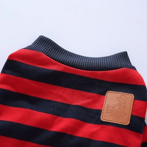 Close-up of red and blue striped dog pajamas with ribbed collar and leather label