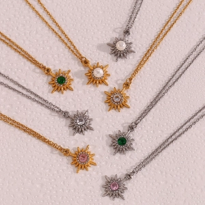 Detail of starburst pendants with colorful zircon and pearl in gold and silver plating