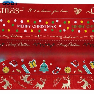 Close-up of red Christmas ribbons with gold reindeer and festive patterns for gift wrapping