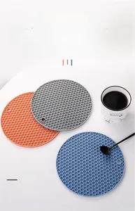 Three-color honeycomb silicone trivets showing flexible heat resistance and anti-slip texture