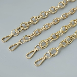 Detailed view of light gold metal bag chains with lobster clasps for handbags