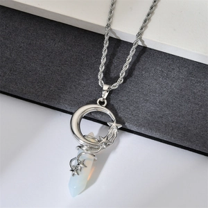Detail of silver twist chain with crescent moon and star stone pendant on tricolor background