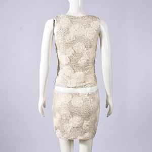 Detail of sequined back and 3D floral appliqués on cream two-piece skirt set