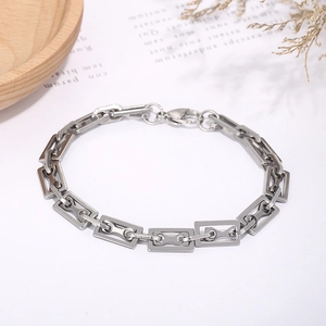 Close-up of geometric stainless steel link chain with rectangular nodes and lobster clasp