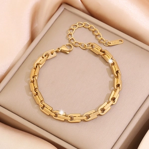 Macro view of gold stainless steel chunky chain bracelet with lobster clasp in a jewelry box