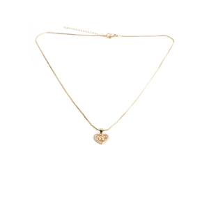 Close-up of golden heart pendant with MAMA lettering and pavé crystals on a fine chain