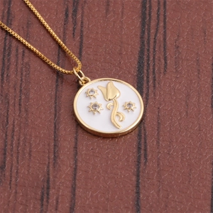 Close-up of gold chain necklace with white enamel floral pendant and star details