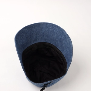 Detail of denim bucket hat showing black lining and adjustable drawstring wind cord