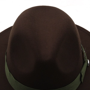 Close-up of brown wool fedora hat with dark green ribbon and silver buckle detail