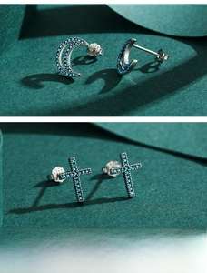 Macro shot of S925 sterling silver crescent and cross earrings with turquoise inlay