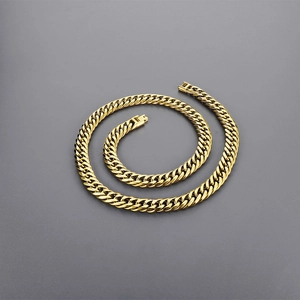 Detail of gold curb chain necklace with polished links and secure fold-over clasp
