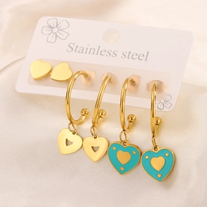 Macro detail of three pairs of 18K gold plated stainless steel heart earrings with enamel