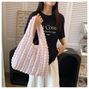 Detail of pink and white striped puff bag with pleated texture and soft ruffled surface