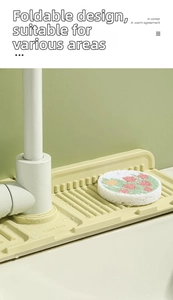 Detailed view of yellow silicone sink drain rack with drainage grooves and faucet hole