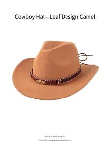 Detail of camel denim cowboy hat featuring a braided band and golden leaf charm decoration