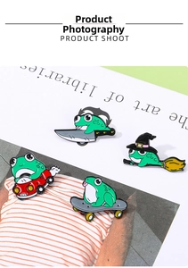 Detail of colorful enamel frog brooches in wizard, skateboarder and car driver styles