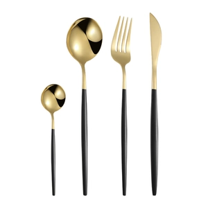 Modern black and gold stainless steel cutlery set including knife, fork, and spoons