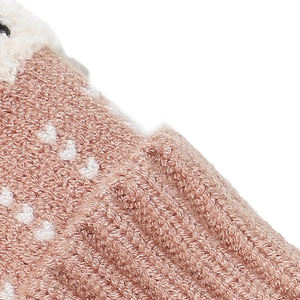 Detailed macro view of pink knitted fabric with heart pattern and white faux fur trim