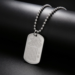 Detailed view of silver titanium steel dog tag pendant with lotus and Heart Sutra engraving