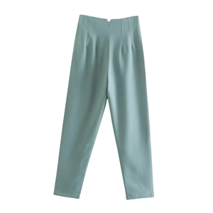 Detail view of high-waisted light blue dress pants with clean tailored seams and straight cut