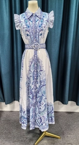 Detail of paisley print sleeveless dress with lapel collar and matching waist belt