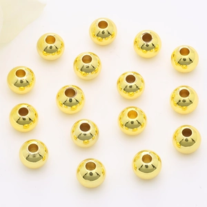 Polished 14K gold filled round spacer beads for DIY jewelry making on white background