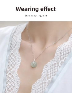 Close-up of a light green Hetian jade Pingan buckle pendant on a silver necklace chain