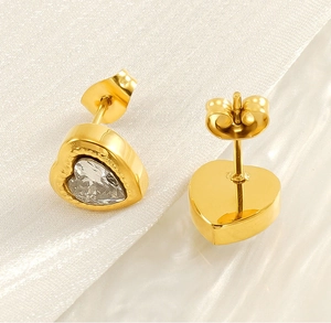 Macro view of gold stainless steel heart stud earrings with sparkling zircon crystals